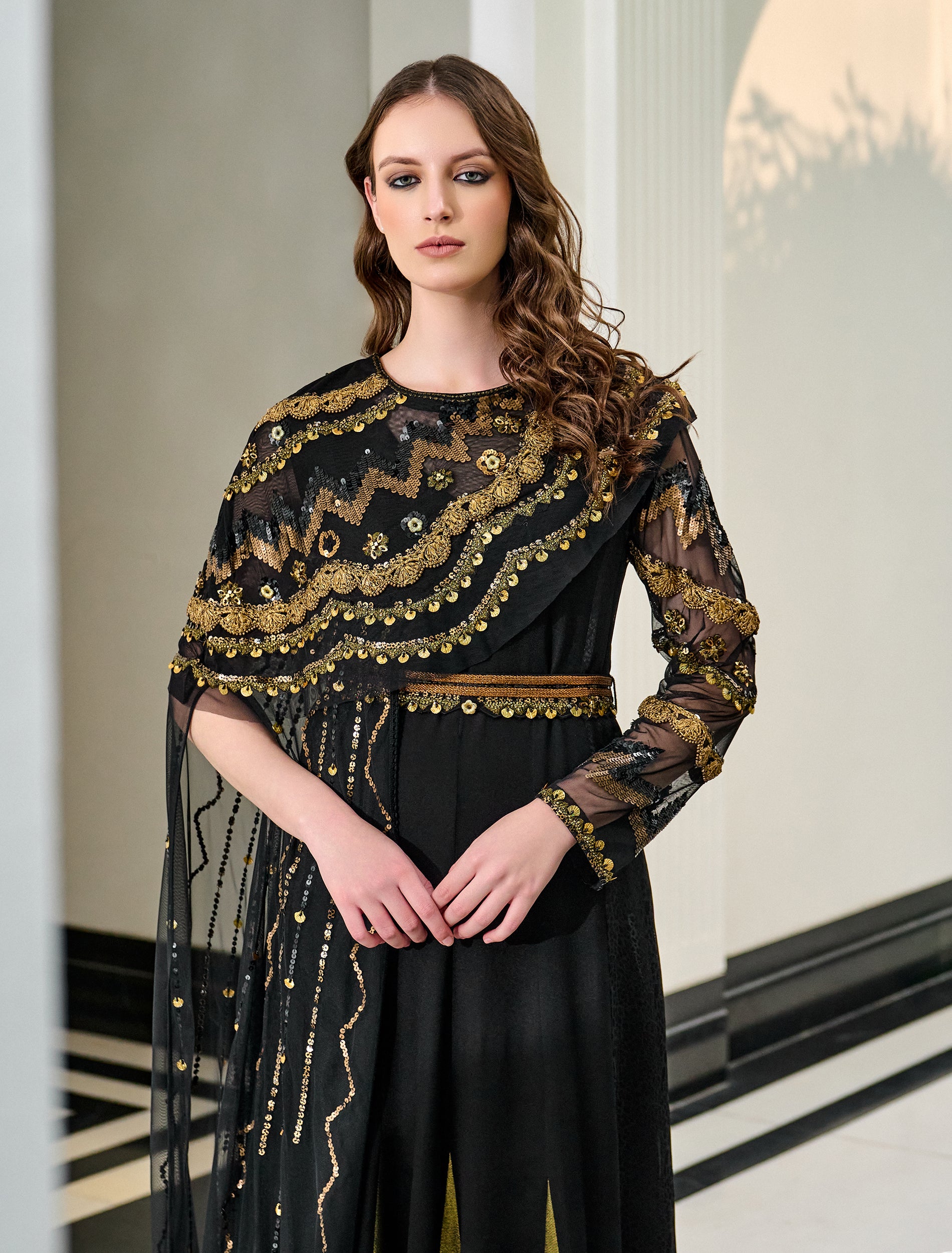 Shop Now: A Striking Black and Gold Dress with Distinctive Embroidery Accents and a Cape!