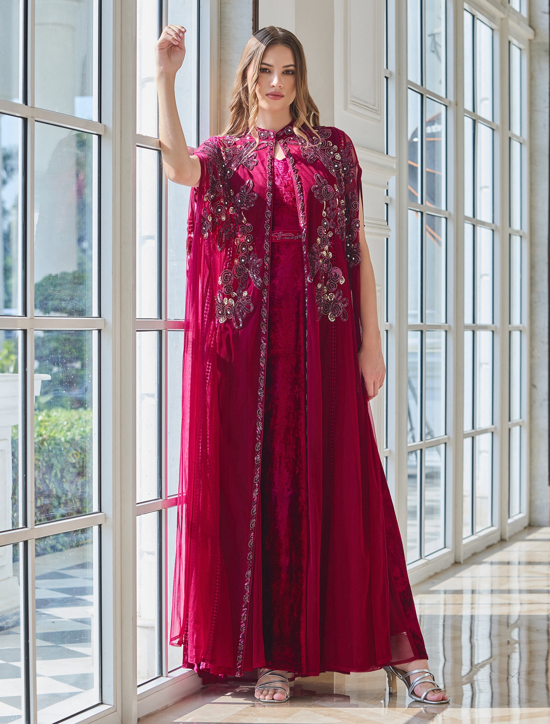Maxi fuchsia dress with floral embellishments and a sheer cape