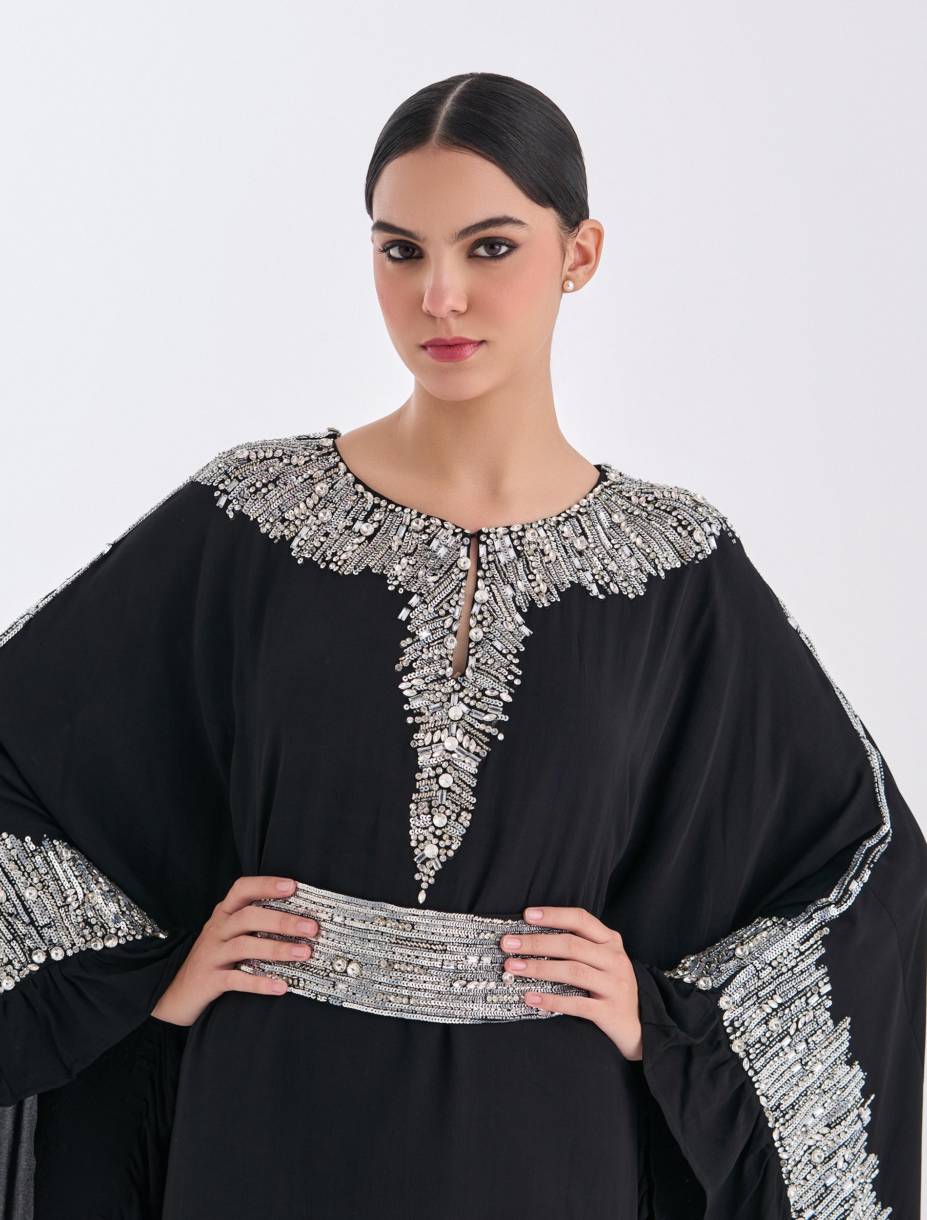 Elegant black long sleeve evening dress with silver embellishments and waist belt